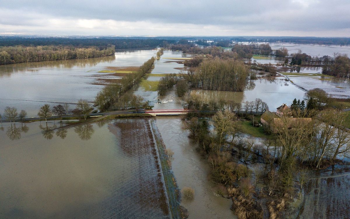 Drone view of a river that has burst its banks and flooded the surrounding fields